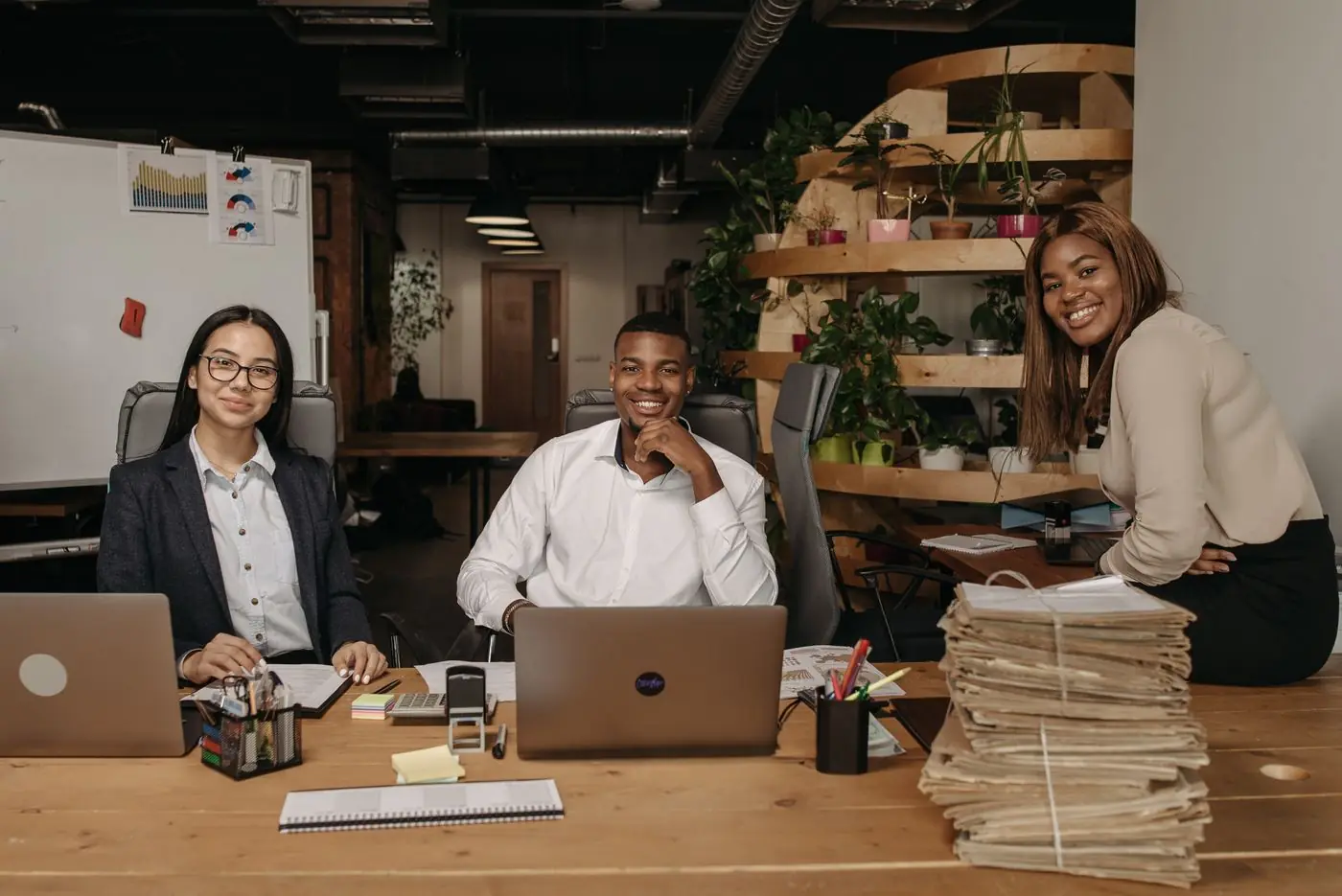A team reviewing work on laptops in an office